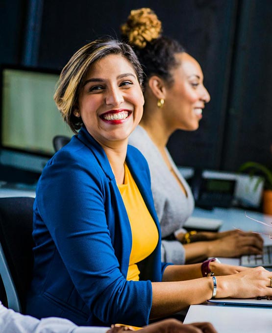 Two ladies working on laptops