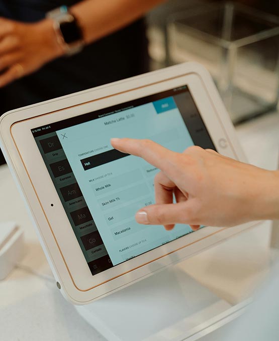 Person typing on a point of sale machine